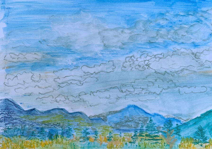 Blue sky with white puffy could outlined in silver over White Mountain in New Hampshire. Yellow, green and blue foliage are at the bottom of the landscape.